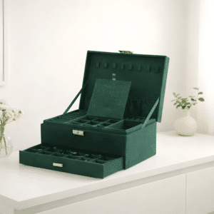 Åbent smykkeskrin i grøn farve med flere skuffer og blødt velourindtræk til ringe, øreringe, halskæder og armbånd. Organiseret og beskyttet opbevaring af smykker.